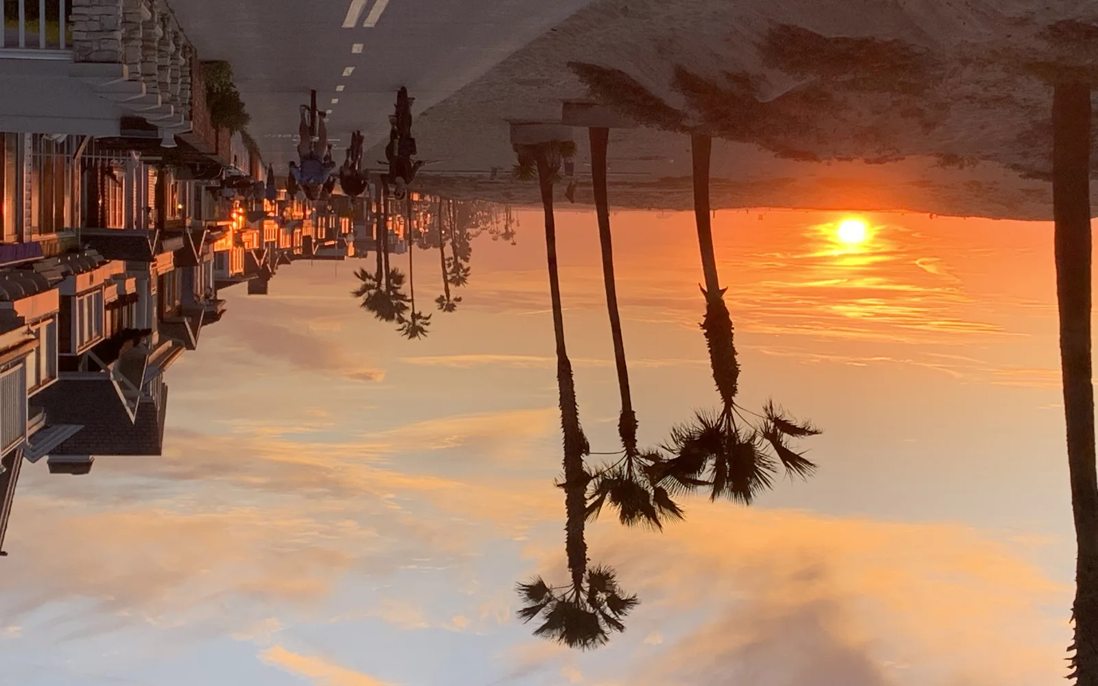 Newport Beach oceanfront boardwalk at golden hour with calm waters and coastal architecture